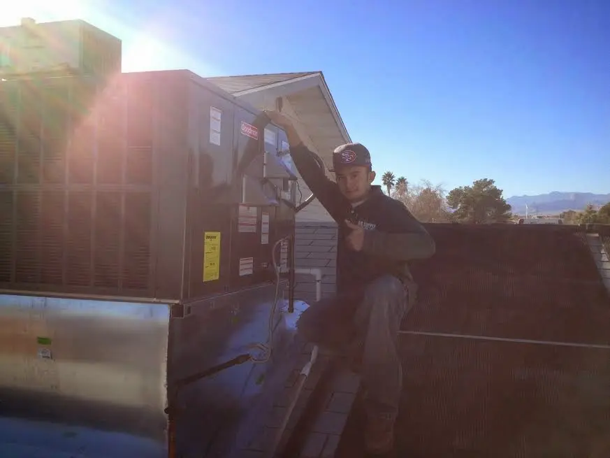 HVAC technician performing Boiler Repair on a rooftop unit in Courtland